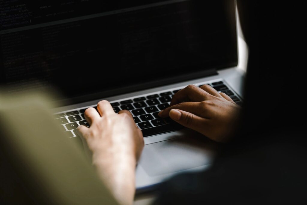 A person typing on a laptop computer.