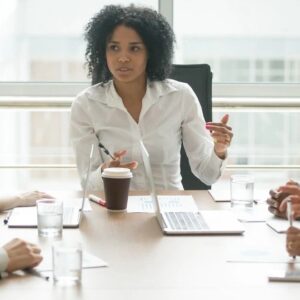 Professional woman presenting during a business meeting.
